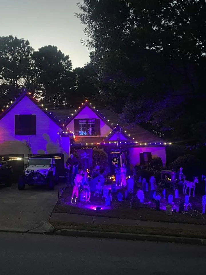 Purple Halloween roofline and yard lighting display