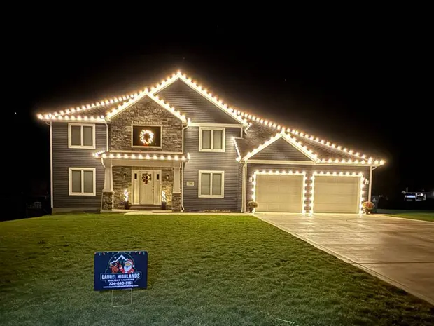 Professional roofline lights outlining a two-story home