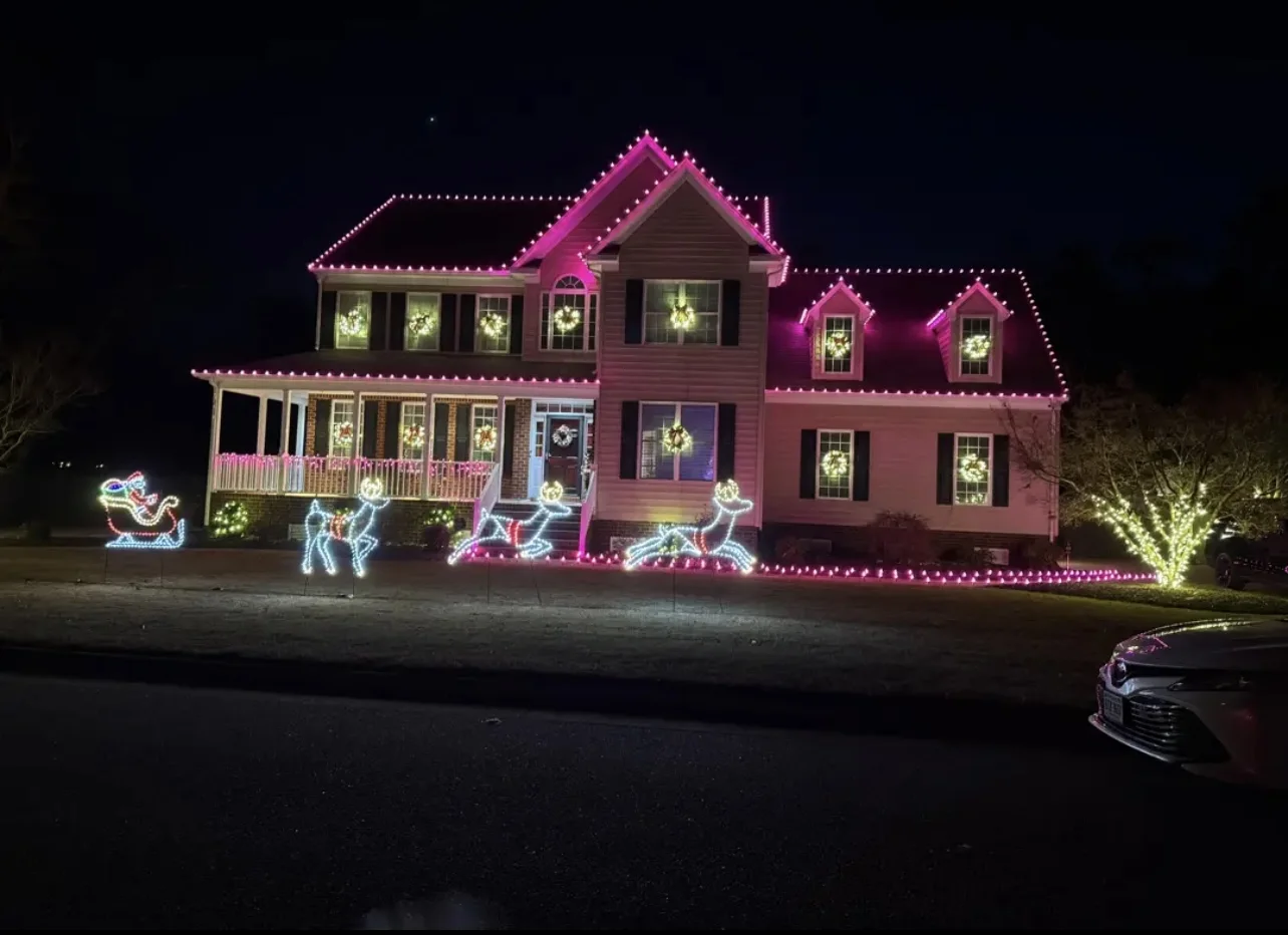 Pink Christmas roofline lights with animated reindeer and sleigh